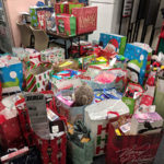 Destined to make the holidays merrier for local boys and girls, gifts await pickup near the Student Activities Office.
