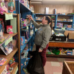 Sammie L. Davis, coordinator of diversity and cultural life, ponders the next selection for her gift bag.