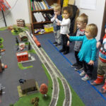 Older toddlers watch and wave as the train makes its rounds.