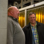 A clearly enjoyable meeting of Harpster (right) and David R. Cotner, dean of industrial, computing and engineering technologies, featured a peek at the in-progress expansion of the school's welding labs.