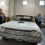In College Avenue Labs, the group inspects a limousine formerly used by the Milton Hershey School. The vehicle, on extended loan from the Antique Automobile Club of America Museum, represents a multiyear project for Penn College students.