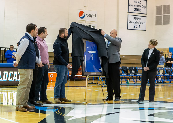 John Vandevere (right), director of athletics, assists in the unveiling ...