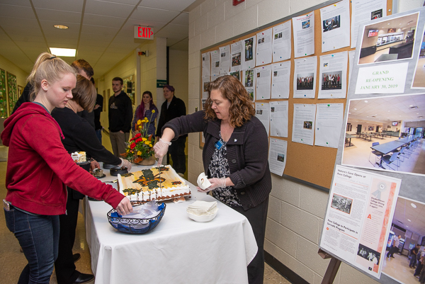 Cheryl Y. Hammond (right), Dining Services' special events manager, serves cake to eager students.