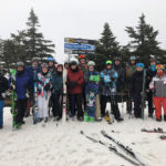 Penn College Ski and Snowboard Club members, along with faculty adviser Steven J. Moff (second from left) enjoy winter fun at Killington. Student leaders of the campus organization include Gabriel J. Perl, president (front and center in rust jacket); board member Emily R. Sillaman (to his left); and treasurer Jack H. Farrar (back row, beneath the directional signs).