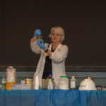 PlastiVan educator Elizabeth Egan demonstrates a particular polymer’s ability to absorb oil.