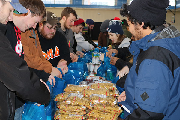Penn College students and employees were among the 250-or-so people who gathered for the More Than a Meal food-packing event.