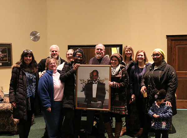 Organizers – including Katie L. Mackey (back row, third from right), director of campus and community engagement at Penn College – surround a photo of James.