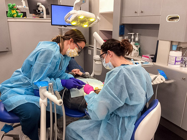 Pennsylvania College of Technology dental hygiene students Abigail S. Way, ’17, of Williamsport, and Rebekah L. Caretti, ’18, of Weedville, provide free preventive dental services to a child during the 2017 Sealant Saturday event at Pennsylvania College of Technology. Volunteer dentists, dental hygienists and dental hygiene students will again provide free services in the Penn College Dental Hygiene Clinic during Sealant Saturday on March 2.