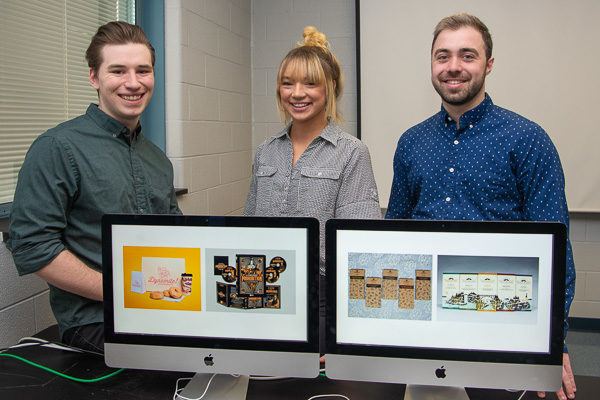 From left: Luke A. Bierly, of Centre Hall; Alexis M. Botek, of Pottsville; and Brandon M. Wolff, of Effort, all seniors in Penn College’s graphic design major, pose with their design work honored in the national Flux Student Design Competition. Joseph N. Colyer (not in the photo), a 2018 graphic design graduate originally from Selinsgrove, earned “Best in Category UX/UI” for his Depression and Bipolar Support Alliance project created when we was a student.