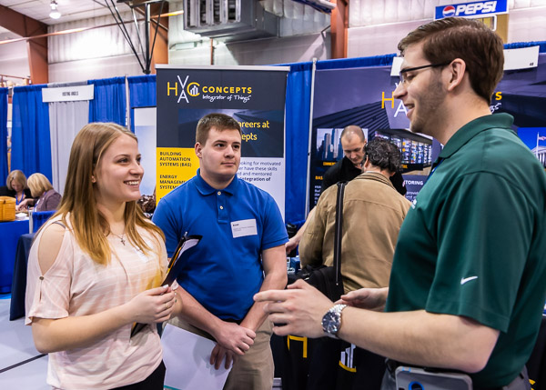 Plastics and polymer engineering technology students Cassie N. Shook, of Wesport, and Evan M. Prough, of Lock Haven, visit with a graduate of their major: B. Braun Medical Inc.'s Daniel M. Dietrich.