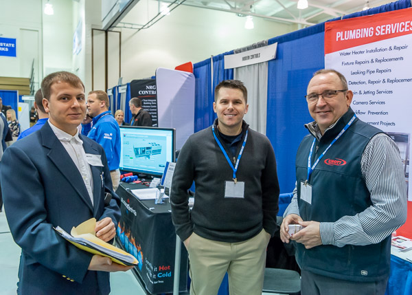 Knott Mechanical's Chris Castle and Cody Setser pose for a photo with Michael M. Ingersoll, of Wayne, a building automation technology student.
