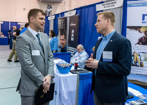 An imminent graduate in civil engineering technology, Kyle L. Kott (left), of Williamsport, explores McTish, Kunkel and Associates with the help of construction management alum Cody I. Gross.