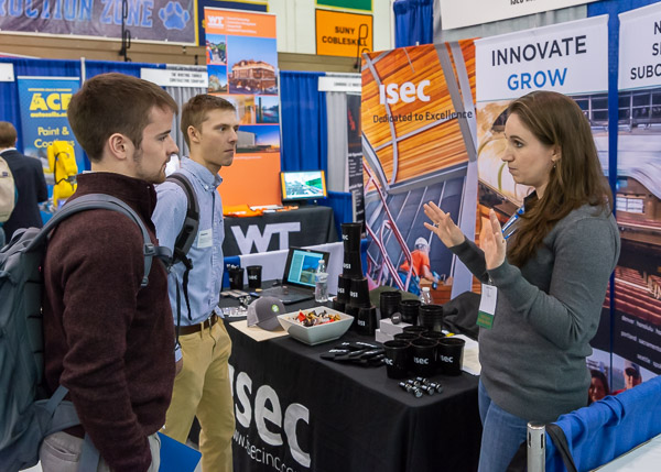The booth of industry partner ISEC Inc. draws residential construction technology and management majors Terrance C. Hillman and Dakota M Shaffer, both of Williamsport. Representing the Maryland-based subcontractor is Caitlin Kriner.