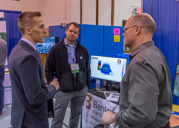 Representatives of Benton Foundry Inc., a supportive friend of Penn College, engage Vasilis S. Tsamoutalidis (left), of Bethlehem. The information assurance and cyber security student is pictured with Brock Smith (center) and Jeff Hall.