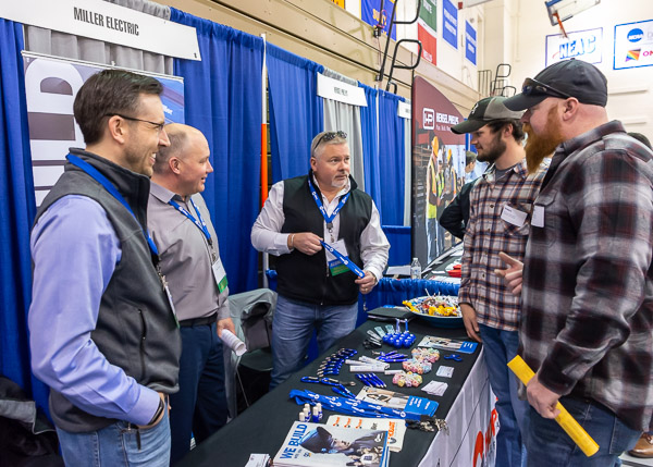 Staff from longtime college partner Miller Electric – from left, Justin Heistand, Jim Wynegar and welding alumnus Richard A. Conrad Jr. – answer questions from welding and fabrication engineering majors Zachery T. Kephart, of Wellsboro, and Alexander W. Bieber, of Freehold, N.J.