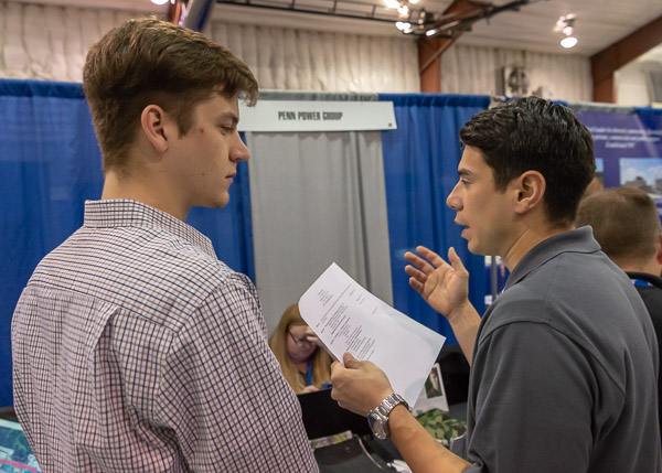 Diesel technology student Brock A. Dull (left), of Chambersburg, learns about the Philadelphia-based Penn Power Group from Jeffrey Fertig.