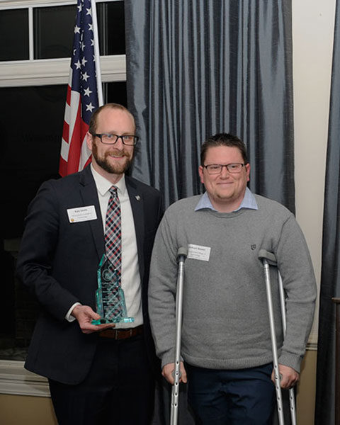 Michael Bower (right) accepts his father's award from Penn College's Kyle A. Smith.
