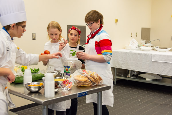 The New Cuisines badge inspires Girl Scout Cadettes to cook foods from different cultures. 