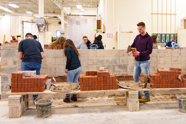 Courses rise at the bricklaying station.