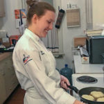 Callahan prepares seared scallops.