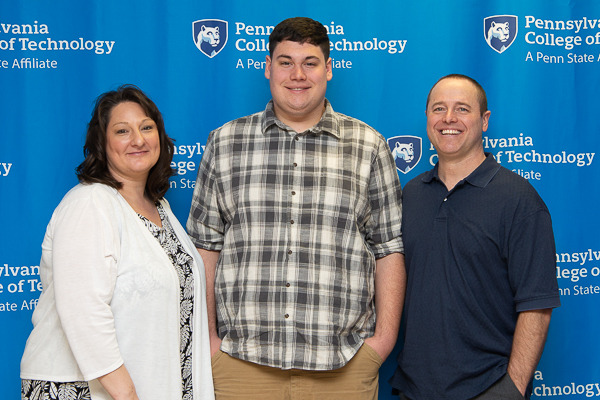 Colton M. Long, electronics and computer engineering technology, and his parents pause to make a memory. Long is recipient of the James P. Bressler Scholarship. 