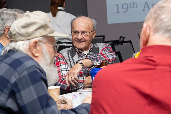 Marlyn Stauffer, ’63, mechanical drafting, enjoys an early morning coffee klatch with former classmates.