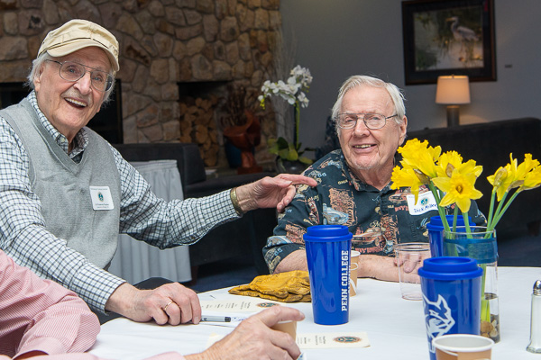 The bright smiles of D. Frederick Wascher (left), ’56, automotive mechanic, and C. Richard Miller, ’51 automotive, add to the palette of Wildcat blue and daffodil yellow.