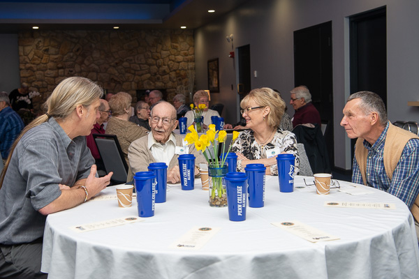 Timothy L. Yarrington (left), instructor, brewing and fermentation science, converses with John Hertel, ’48, electric and acetylene welding, and ’49, agricultural equipment and repair; Hertel’s daughter Sandra; and Edmond Wozniak, ’61, machinist, pattern making-wood. 