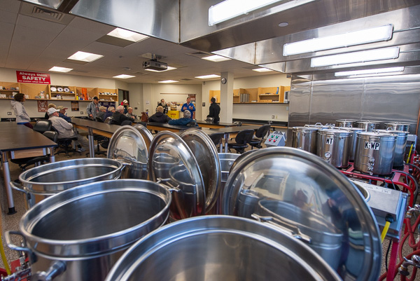 Thomas C. Heffner, assistant dean of sciences, humanities and visual communications, with alumni in the brewing lab