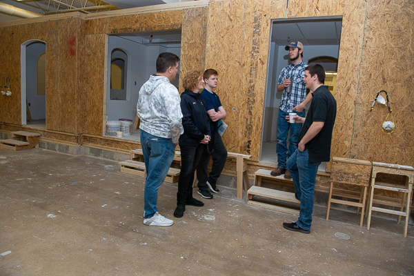 A family from Hershey tours construction labs with Scott R. Martin (on steps) and Jacob Wallbillich. Martin is enrolled in building construction technology; Wallbillich is in residential construction technology and management: building construction technology concentration.
