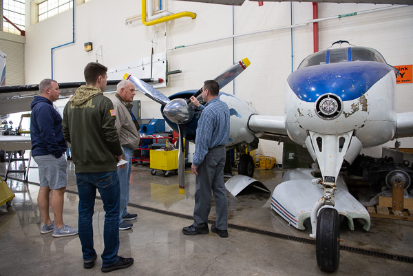 A three-generation tour of the Lumley Aviation Center is assisted by Bill F. Stepp III (center), associate professor of aviation. 