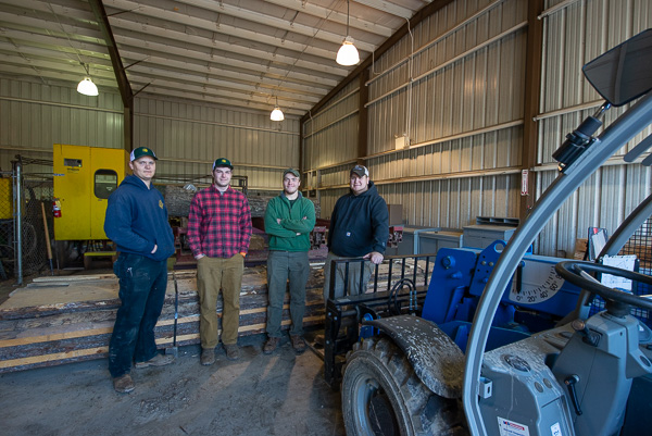 Happy to host visitors to the sawmill are forest technology students (from left): Michael J. “M.J.” Wazer, Cayman A. Trostle, Seth D. Bechdel and Cameron J. Hutchinson.