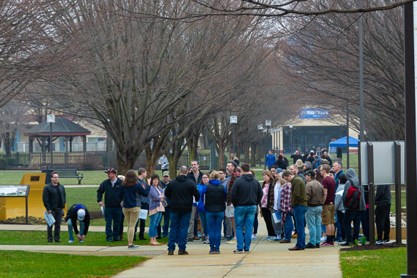 Crowds congregate near The Veterans Fountain, sticking with their tour group or contemplating their next destination.