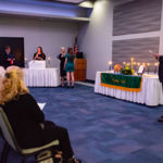 President Gilmour pins an inductee during the candlelit PDC ceremony, joined by (from left) Bridgens, Miller and Gregory.