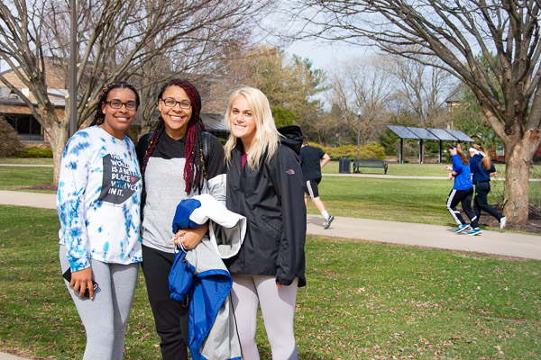 Two members of the women's basketball team – Ja'Quela Dyer (left), of Dover, Del., and Tori P. Wolfe (right), of Dalmatia – stop in their tracks, along with Dyer's sister, Jonice, a culinary arts technology major.