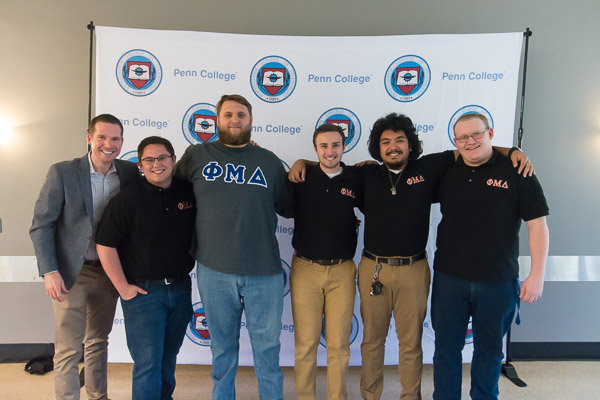 ... who marked the occasion in the company of his Phi Mu Delta brethren and (at left) adviser Brian J. Schurr, of Counseling Services.