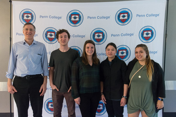 Adviser Thomas E. Ask (left), professor of industrial design,  enjoys a yearend get-together with members of the Society of Inventors and Mad Scientists.