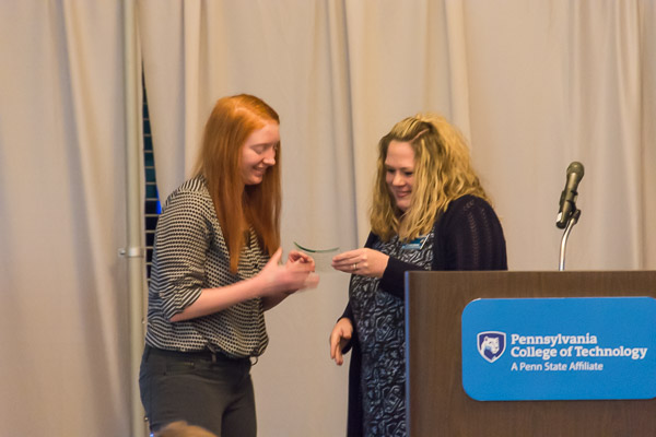 WOGA president Hallie S. Harriman (left), an information technology sciences-gaming and simulation major from Mifflinburg, receives an award from Shannon Skaluba, student organization and information center specialist.