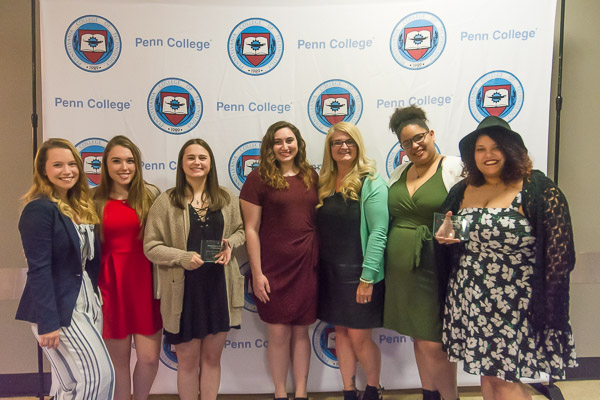 Representatives of the Wildcat Events Board – including adviser Trisha M. Temple, coordinator of student activities programming –  help celebrate the organization's 20th-anniversary year.