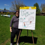 Against an apt array of solar panels, CPE Alexis J. Medero, a civil engineering technology student from Levittown, invites passersby to join the fun.