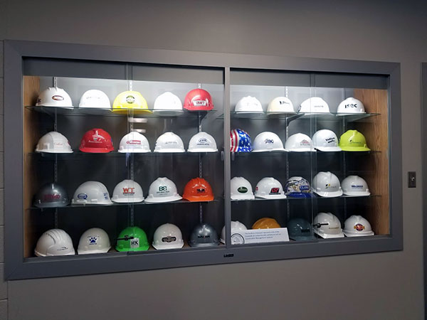 A display of hard hats represents a fraction of the hundreds of employers that recruit the college's construction management grads.