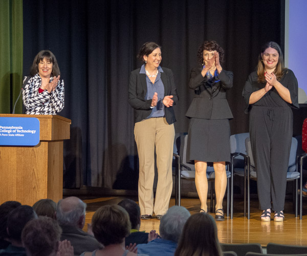Officers applaud as the Omega Theta chapter of Sigma Theta Tau is officially chartered. From left are Beth Baldwin Tigges, president of Sigma Theta Tau International, and chapter officers Dawn E. Murafka, secretary; Donnamarie Lovestrand, vice president; and Monica A. Flexer, president.