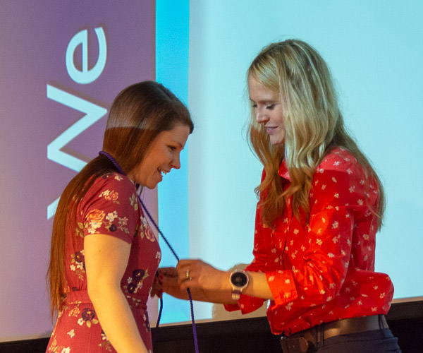 Rachel L. Carlson, of Blossburg, accepts her honor cord from Tushanna M. Habalar, instructor of nursing.