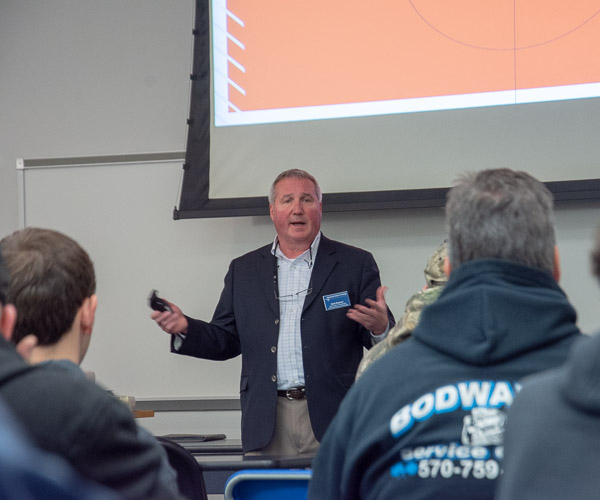 Brett A. Reasner, dean of the School of Transportation & Natural Resources Technologies, offers an informative talk to a full room in College Avenue Labs.