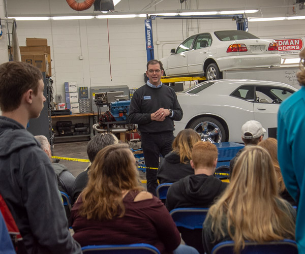 Christopher J. Holley, assistant professor of automotive, talks with a standing-room-only crowd eager to watch a Charger run on the dyno.