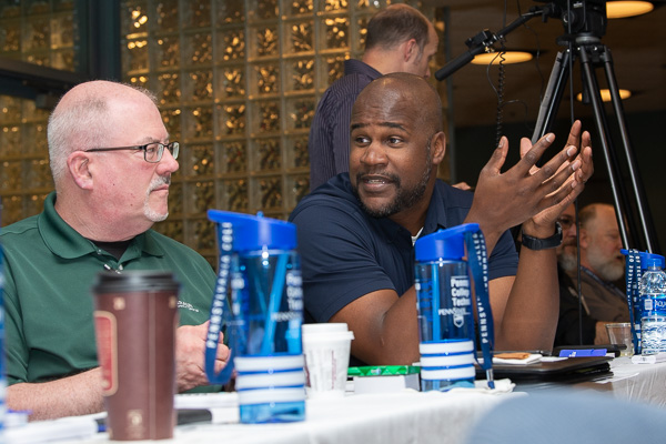 Albert Jones (right), director of human resources at First Quality, and John Keefe, mold shop manager at B. Braun Medical follow Hummels' directive to discuss “learning cultures” within their companies.