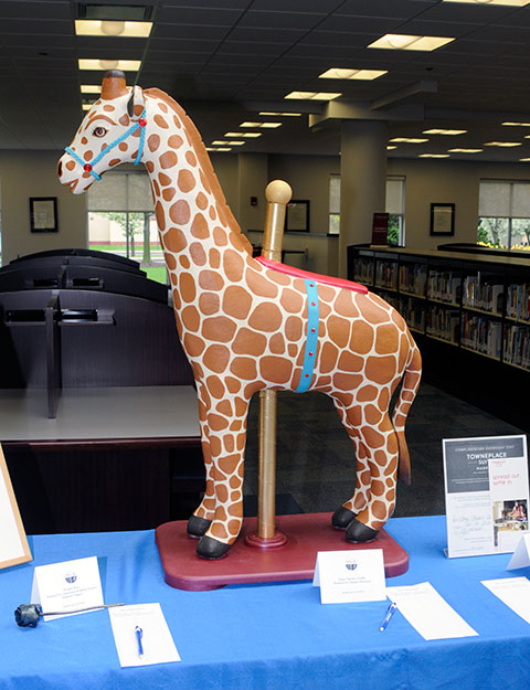 Dennis R. Dorward, associate professor of construction management/building construction - who, in past years, fashioned winged pigs and elephants, added a papier-mache carousel giraffe to this year's sale.