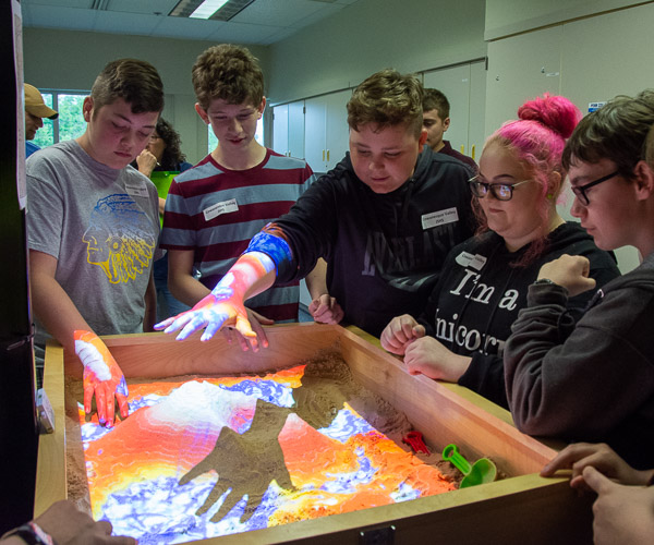 Visitors from Cowanesque Valley experiment with augmented reality to explore topography and what civil engineers and surveyors must understand about the land. The session was led by Brad H. Lyon, assistant professor of civil engineering technology, and students