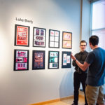 Luke A. Bierly talks about his work with a gallery patron.