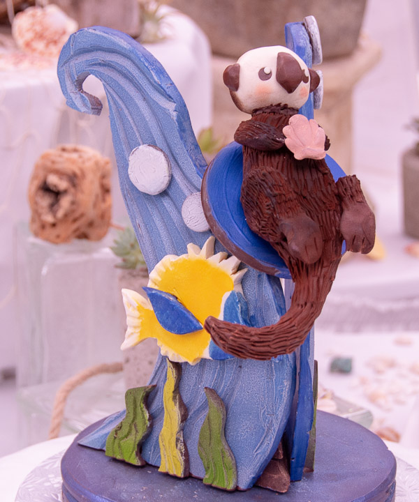 A sea otter rides the waves on a chocolate sculpture by Cyril L. Hunter, of Hughesville.